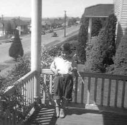 Marie Vautier poses on the front porch of house at 2317 Grand street in Everett about 1949
