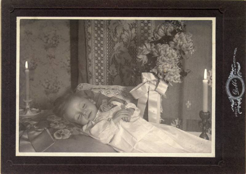 A funeral portrait of a child, Miss Marion Jessop. Photographer: Dobbs, Holly St., New Whatcom, Wash. Don't know who this child is.