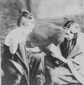 Elaine O'Rouark with her older sister Allegra O'Rouark playing indians