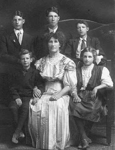 portrait of The family of George Vautier Sr. and Bridget Ellen Jessup Vautier.  Back row from left to right: Joseph Vautier, George Vautier Jr. , Eddie Vautier; Front row: Percy Vautier, Ella Vautier, Rita Vautier