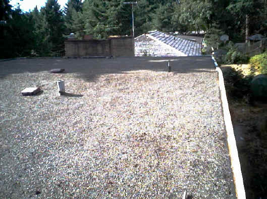 move the gravel around with a blower.  In this way the debris blows away leaving the gravel.  Most of the time it worked fine.  Afterwards redistribute the gravel over uneven spots.
