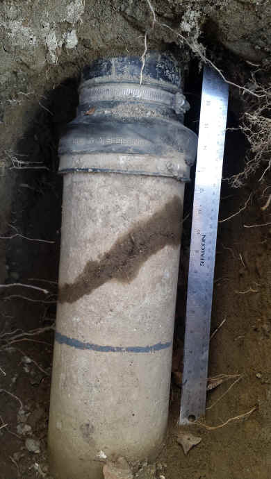 exposed house sewer lateral showing crack